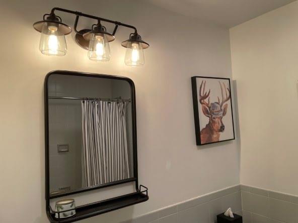 Upstairs full bathroom with vanity and shower.