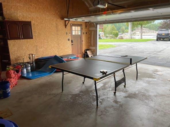 Garage outfitted with games and lake gear.