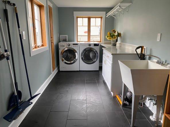 Laundry room with washer, dryer, and folding station.